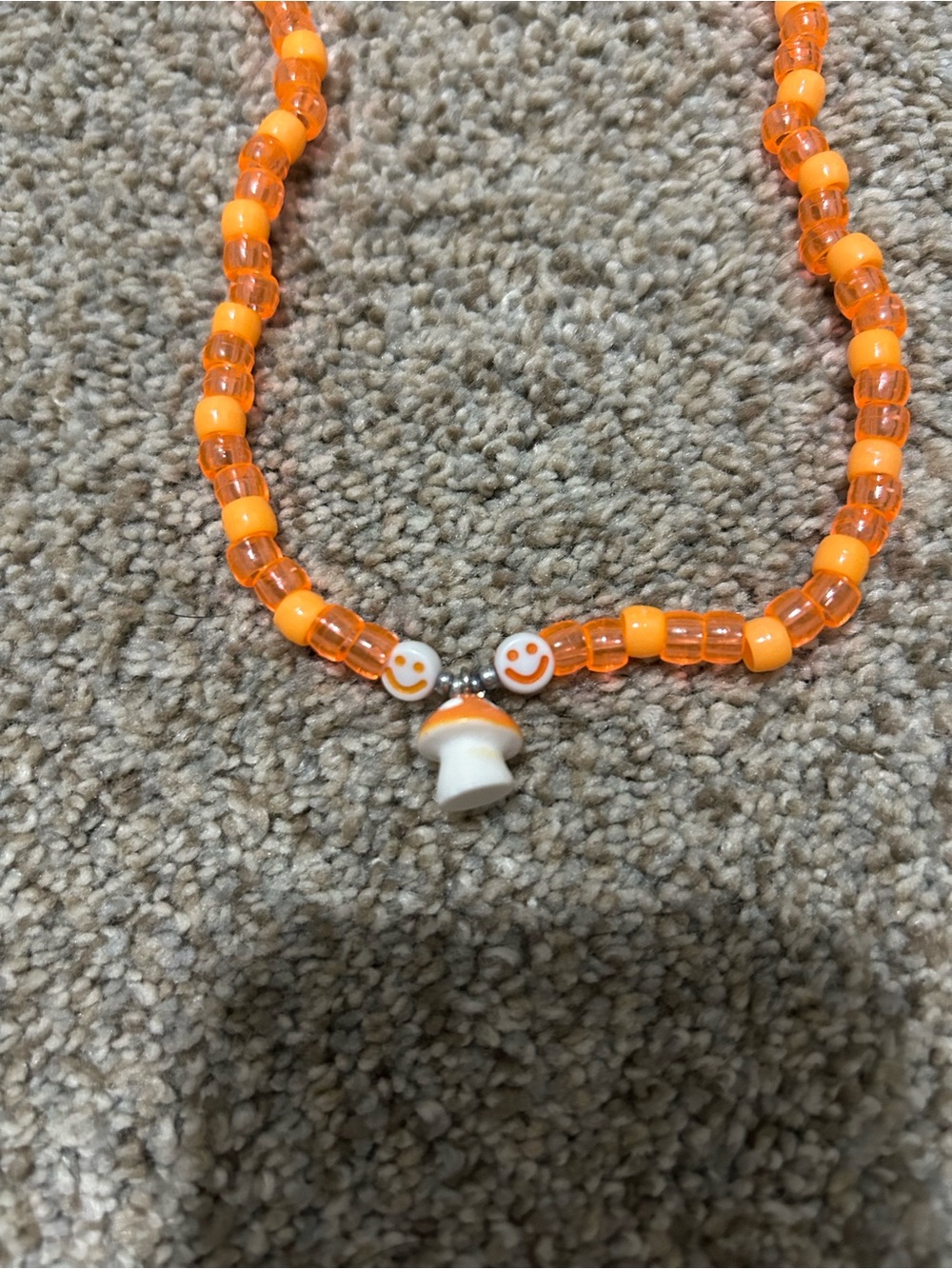 Playful Orange Beaded Necklace with Smiley Beads and Mushroom Charm